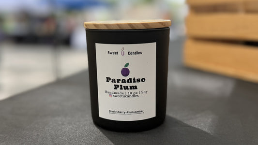 Black matte Paradise Plum 10 oz soy candle with a wooden lid, a dark plum and black cherry scent for Halloween