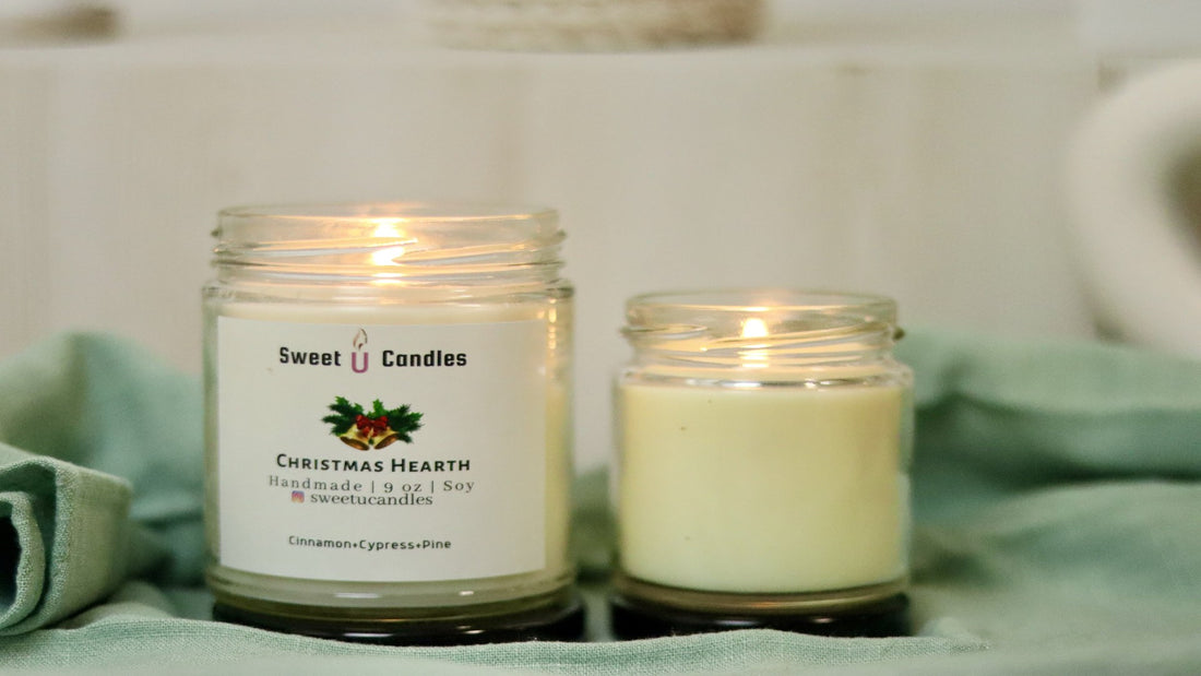 Two lit Sweet U Candles soy candles glowing warmly on a soft sage green cloth, set for a cozy evening wind-down ritual
