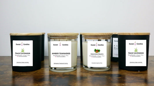 Row of Sweet U Candles soy candles in Sage Lavender, Amber Teakwood, and Christmas Hearth scents lined up on a wooden table