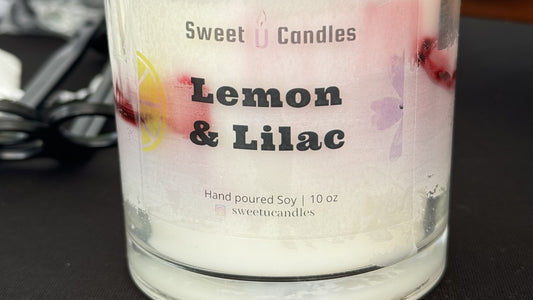 Close-up of a Sweet U Candles Lemon & Lilac soy candle, illustrating a freshly poured candle that needs time to cure before burning