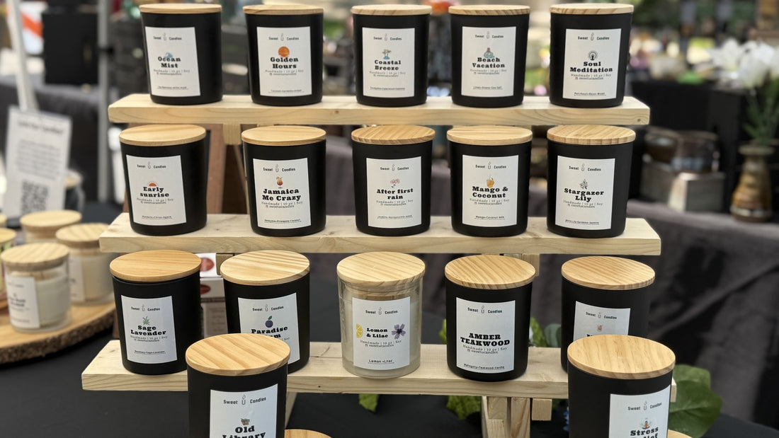 Tiered display of Sweet U Candles soy candles in a variety of scents, showing a full fall candle lineup