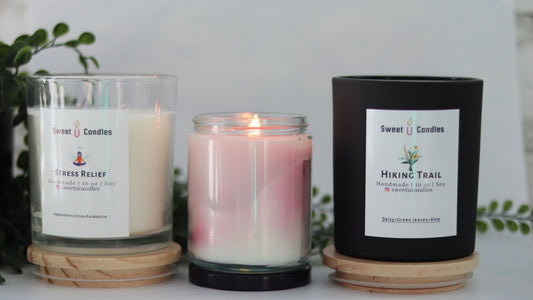 Three Sweet U Candles soy candles in a lineup, including a black matte Hiking Trail jar, styled as a Father's Day gift set