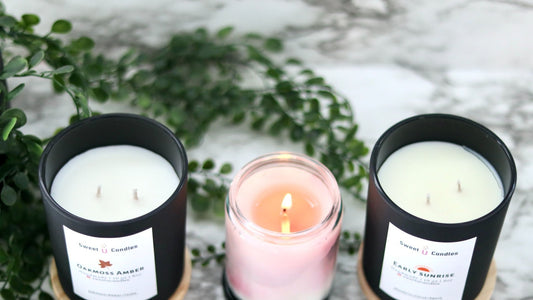 Three Sweet U Candles soy candles in dark matte jars on a marble surface, styled as a Father's Day gift set