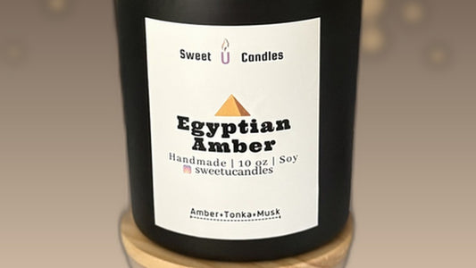 Sweet U Candles Egyptian Amber 10 oz soy candle with warm golden bokeh background — perfect for a summer solstice ritual